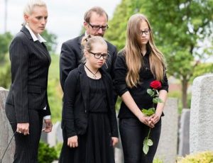 Family mourning over a wrongful death at a funeral.